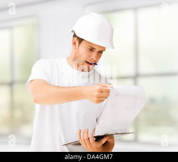 male architect looking at blueprint Stock Photo