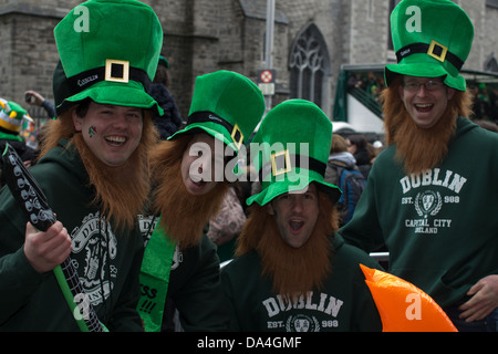 Four male spectators wearing green hats pose for a photograph, St. Patrick's Parade, Dublin, Ireland, 17th of March 2013. Stock Photo