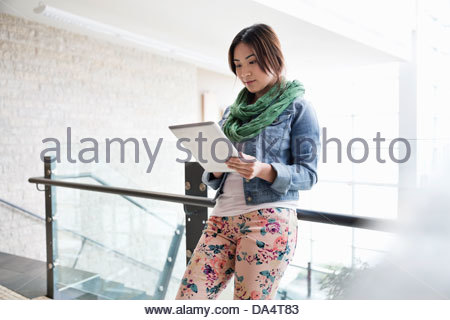 Female student using digital tablet at college campus