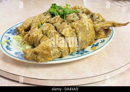 Glutinous Rice Deep Fried Stuffed Whole Chicken Chinese Dish Garnished with Cilantro Stock Photo