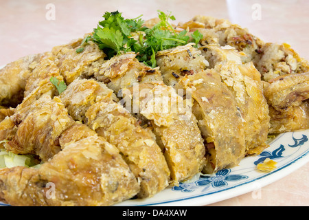 Glutinous Rice Deep Fried Stuffed Whole Chicken Chinese Dish Garnished with Cilantro Closeup Stock Photo