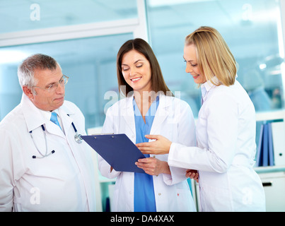 Portrait of successful medical workers discussing plan in hospital Stock Photo