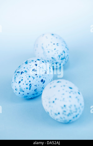 Three pale blue speckled painted easter eggs Stock Photo