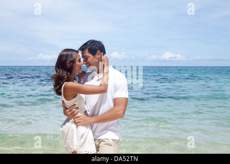 A young couple posing on a beach. Stock Photo