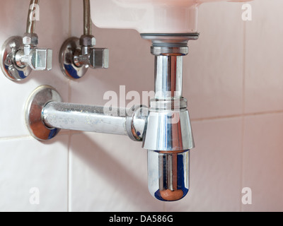 used metal sink siphon and drain closed up Stock Photo