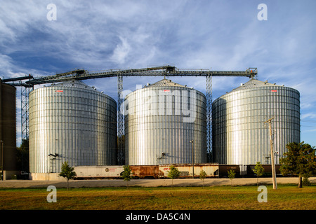 Rail cars await loading at the Shakopee River Terminal grain storage bins. Stock Photo