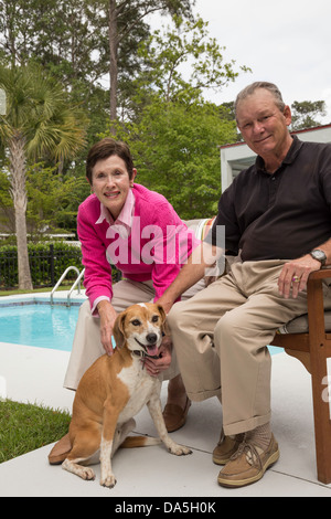 Successful Mature Couple Poses by their Swimming Pool, USA Stock Photo