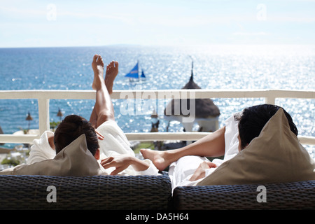 A couple relaxing on a balcony. Stock Photo