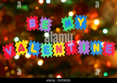 This is love note Be my Valentine, with Christmas tree lights in background. Stock Photo