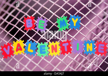 This is love note Be my Valentine, with pink mesh in background. Stock Photo