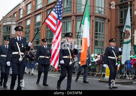 A uniformed colour guard carries United States and Irish flags in Dublin’s St Patrick’s parade, Ireland, in March 2013. Stock Photo