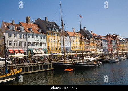 Copenhagen Denmark EU 17thc building with colourful facades in Nyhavn with open air cafes and restaurants on canal waterfront Stock Photo