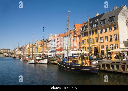 Copenhagen Denmark EU 17thc building with colourful facades in Nyhavn with open air cafes and restaurants on canal waterfront Stock Photo