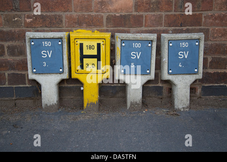 Fire hydrant water locator signage and sluice valve indicators on a UK street pavement Stock Photo