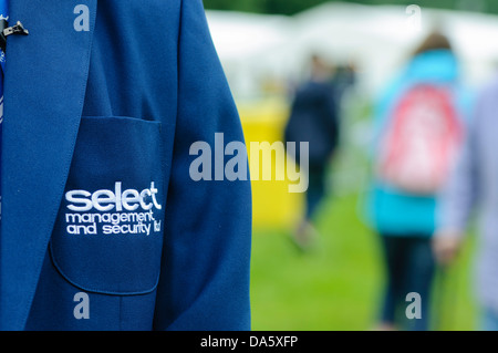 Security guard wears a formal uniform for Select Security, a provider of security and event staff in Northern Ireland. Stock Photo