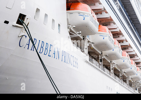 Lifeboats on the side of the Caribbean Princess cruise liner, operated by Princess Cruises Stock Photo