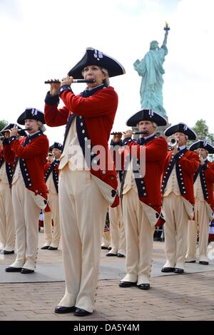 New York, USA. 4th July, 2013. Members from the Old Guard Fife and Drum Corps perform at the re-opening of the Statue of Liberty July 4, 2013 at Liberty Island, NJ. The park was reopened months after super storm Sandy swamped the tiny island. Credit:  Planetpix/Alamy Live News Stock Photo