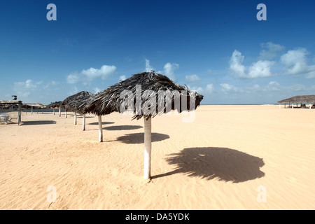 umbrella in desert under blue sky Stock Photo