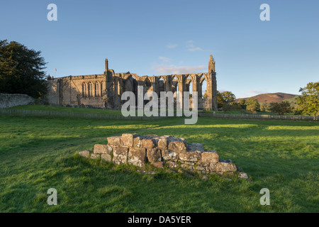 View from south of sunlit, ancient, picturesque monastic ruins of Bolton Abbey & priory church, in scenic countryside - Yorkshire Dales, England, UK.