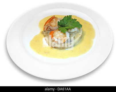 scallops in sauce with spices, on a white plate Stock Photo