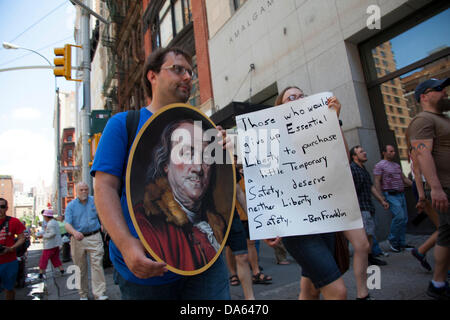 New York, USA. 04th July, 2013. Protesters march down Broadway in NYC on July 4th to Federal Hall, where the Declaration of Independence was originally signed, in protest to revelations that the NSA (National Security Agency) spies and collects data daily on US citizens. Credit:  David Grossman/Alamy Live News Stock Photo