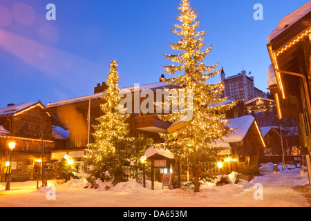 Gstaad, winter, village, night, dark, canton, Bern, Bernese Oberland, Switzerland, Europe, Christmas trees, Stock Photo