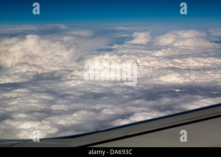 Wing of an airplane on cloud sky Stock Photo