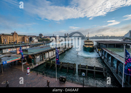 A ferry leaves Circular Quay on the way to the iconic Sydney Harbour Bridge Stock Photo