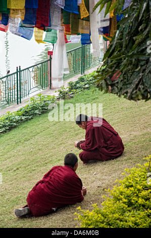 Monks sitting by Muchalinda lake. Bodhgaya, Bihar, India Stock Photo