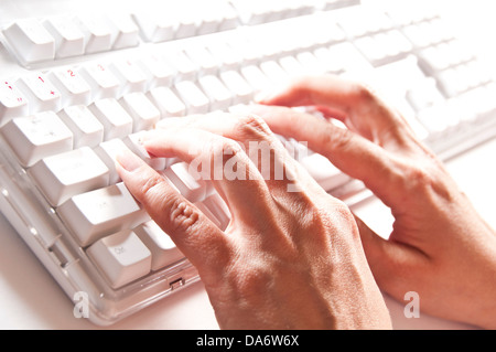 woman typing on a keyboard Stock Photo
