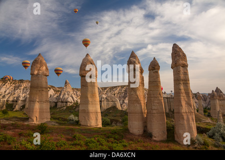 Hot air balloons flying over rock landscape at Cappadocia, Turkey. Stock Photo
