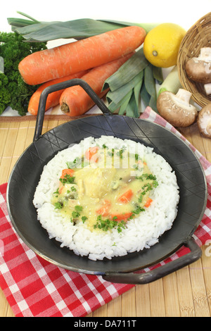 a pan with rice and colorful chicken fricassee Stock Photo