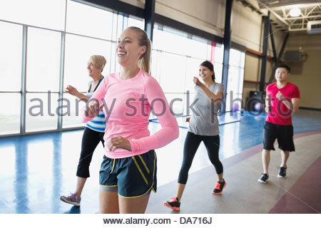 Woman jogging with friends in fitness center