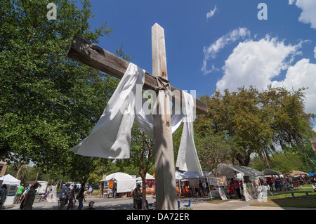 Christian Cross erected by a nearby Methodist Church hovers over the annual Spring Arts Festival in Gainesville Florida. Stock Photo