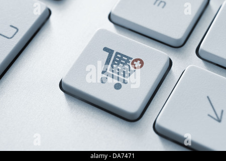 Button with shopping cart icon on a modern computer keyboard. Stock Photo