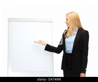 businesswoman pointing at white blank flipchart Stock Photo
