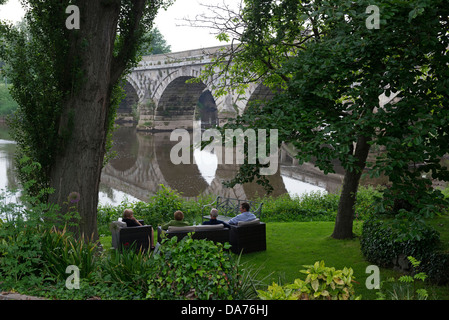 Customers from The Mytton & Mermaid Country House Hotel enjoying the view of the old bridge across the River Severn. Atcham. Stock Photo