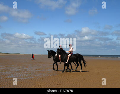 Holkham, UK. 04th July, 2013. The Household Cavalry Mounted Regiment on Holkham Beach. Members of The Household Cavalry Mounted Regiment and their horses enjoy the start of their summer camp in the sea and on the beach at Holkham in Norfolk. Pic: Paul Marriott Credit:  Paul Marriott/Alamy Live News Stock Photo