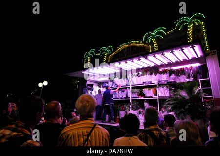 Zurich, Switzerland. 5th July, 2013. In the center of Zurich, Switzerland, a worldwide big festival is held for three days. Parties, Carnival, fairground attractions, markets and food and drink stands everywhere.  - crowd people in front of flower merchants. Stock Photo