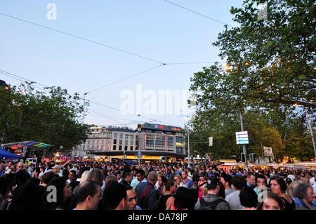 Zurich, Switzerland. 5th July, 2013. In the center of Zurich, Switzerland, a worldwide big festival is held for three days. Parties, Carnival, fairground attractions, markets and food and drink stands everywhere.  - crowd people in the center of Zurich Stock Photo