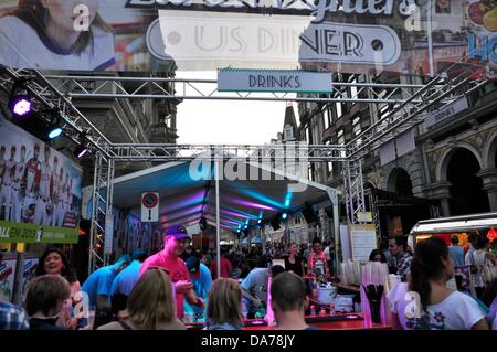 Zurich, Switzerland. 5th July, 2013. In the center of Zurich, Switzerland, a worldwide big festival is held for three days. Parties, Carnival, fairground attractions, markets and food and drink stands everywhere.  - crowd people in the center of Zurich Stock Photo