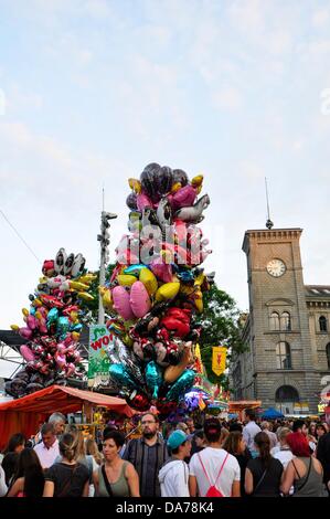 Zurich, Switzerland. 5th July, 2013. In the center of Zurich, Switzerland, a worldwide big festival is held for three days. Parties, Carnival, fairground attractions, markets and food and drink stands everywhere.  - crowd people in the center of Zurich Stock Photo