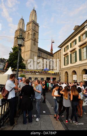 Zurich, Switzerland. 5th July, 2013. In the center of Zurich, Switzerland, a worldwide big festival is held for three days. Parties, Carnival, fairground attractions, markets and food and drink stands everywhere.  - crowd people in the center of Zurich Stock Photo