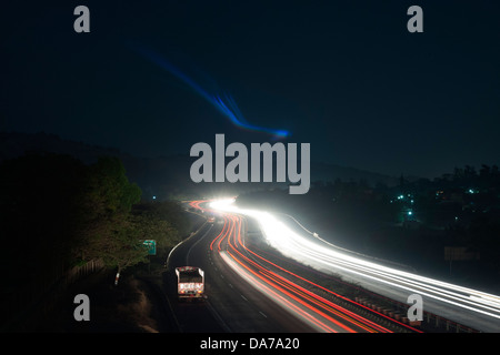 The Pune Mumbai expressway looks magical in the setting sun with vehicles moving around at great speed is a venue for accidents Stock Photo