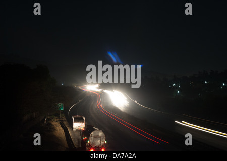 The Pune Mumbai expressway looks magical in the setting sun with vehicles moving around at great speed is a venue for accidents Stock Photo