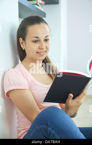 Young attractive lady sitting with a book Stock Photo