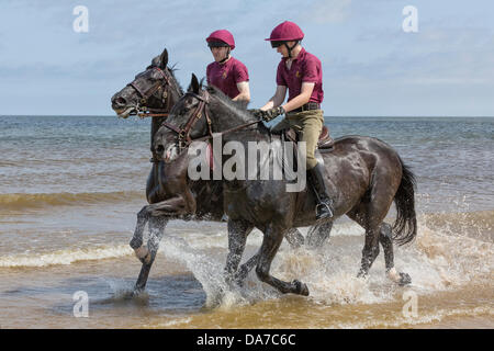 Holkham, Norfolk, UK. 4th July, 2013. The Household cavalry - Two members of the  Lifeguards riding on Holkham beach in North Norfolk during their annual summer camp. Holkham. North Norfolk.England.04 July 2013 Credit:  David Osborn/Alamy Live News Stock Photo