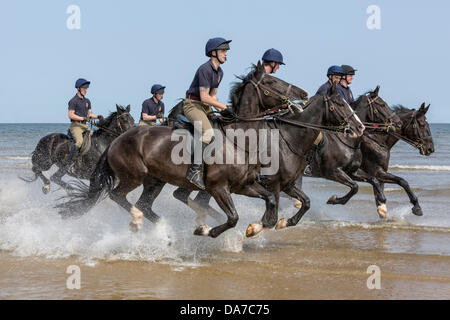 Holkham, Norfolk, UK. 4th July, 2013. The Household cavalry - Riders of the Blues and Royals riding through the sea at Holkham beach in North Norfolk during their annual summer camp. Holkham. North Norfolk.England. 05 July 2013 Credit:  David Osborn/Alamy Live News Stock Photo