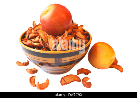 dried pieces and fresh apples in the plate isolated on the white background Stock Photo