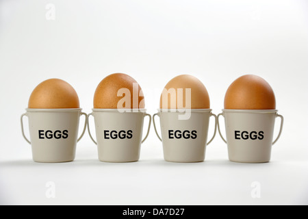 Boiled eggs in cups in a row Stock Photo